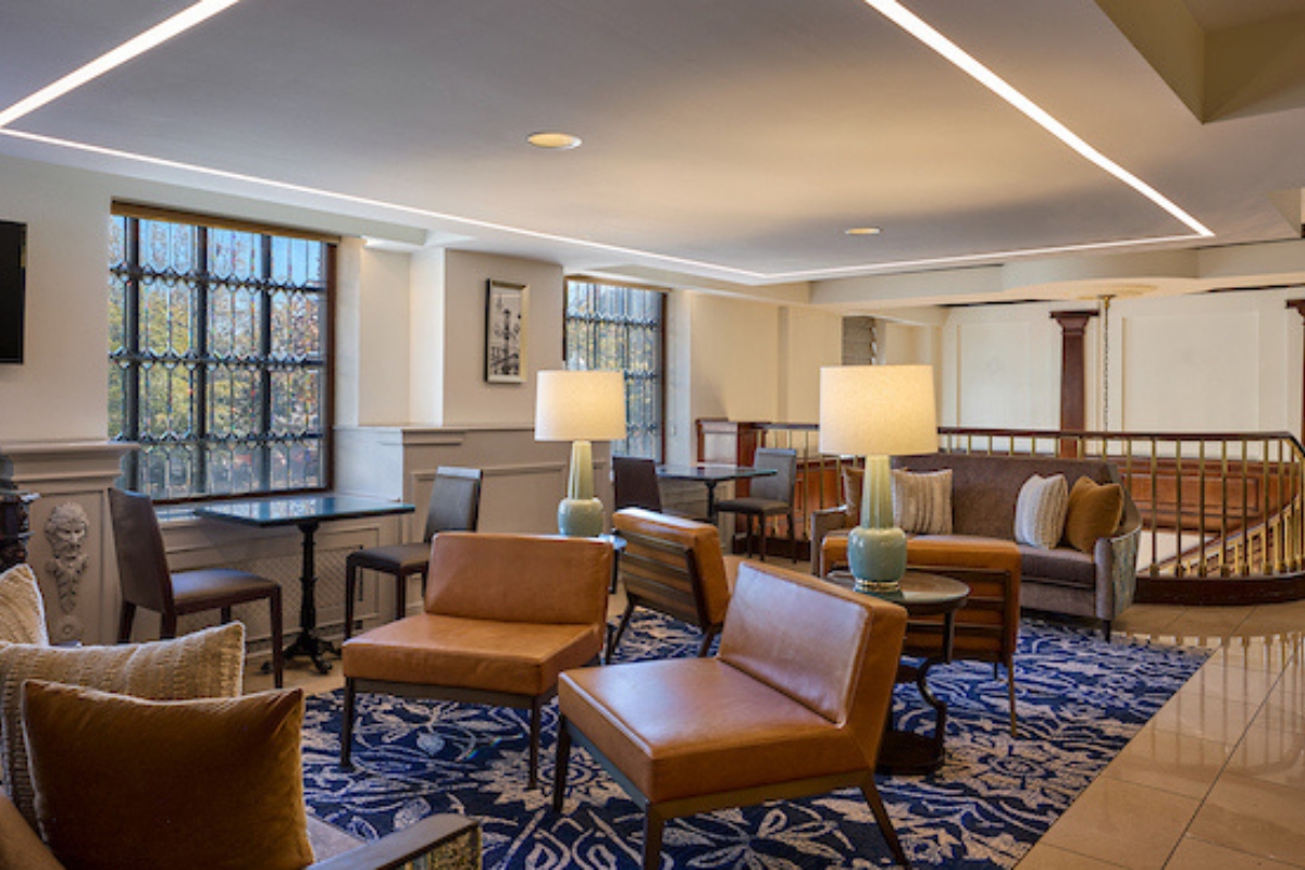 a room with a couch and chairs