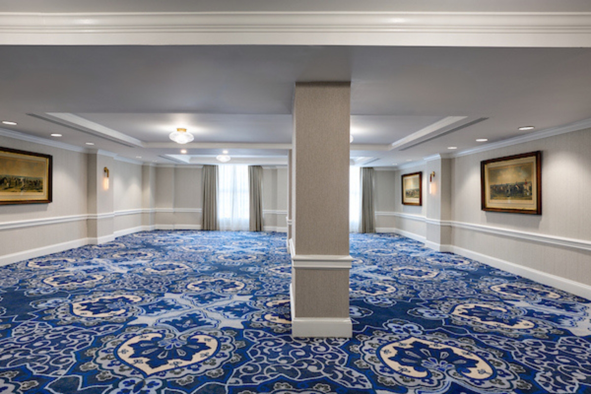 a large room with blue carpet