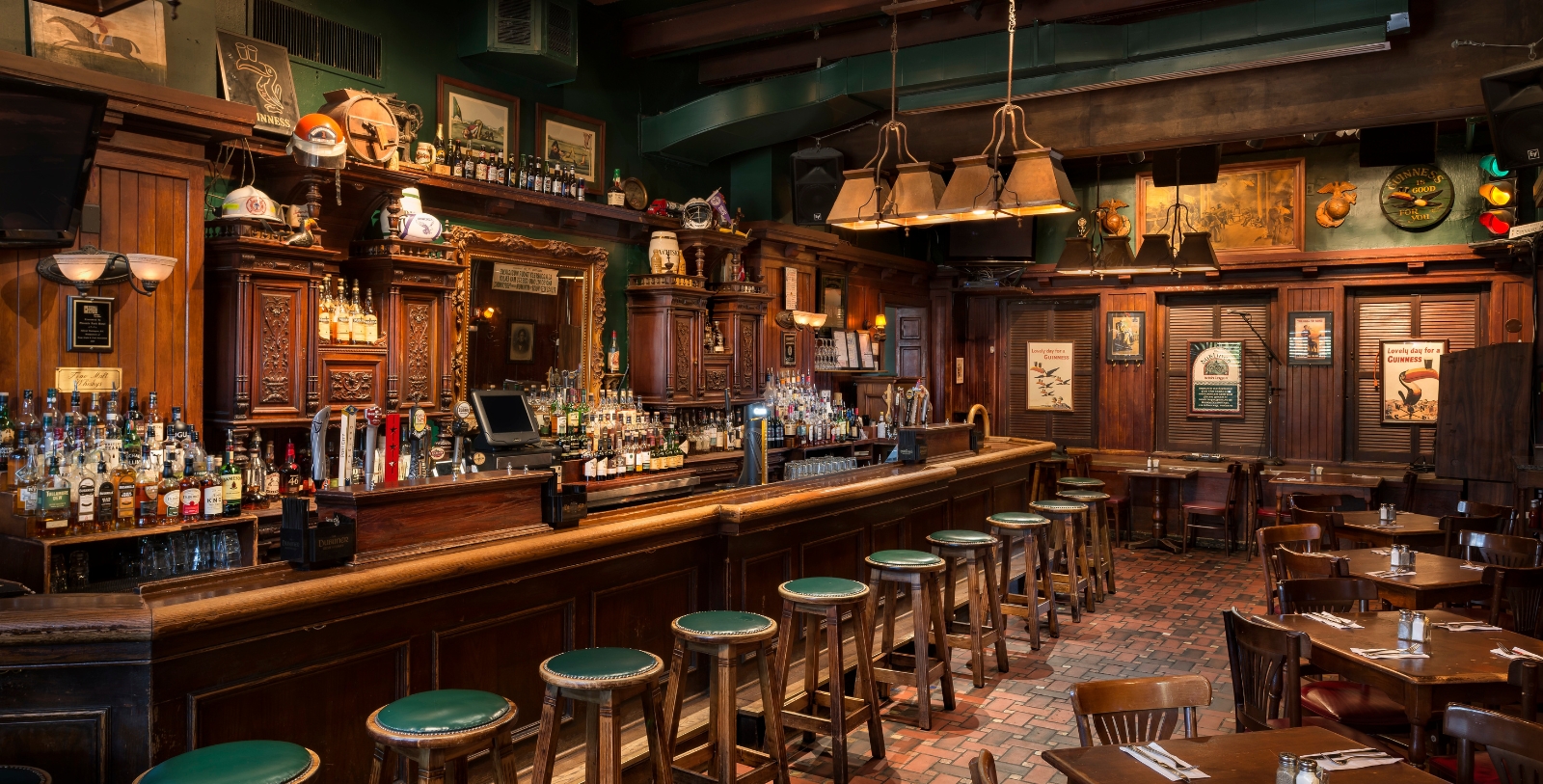 a bar with stools and bottles