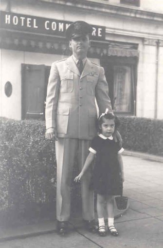 a man in a military uniform standing next to a girl