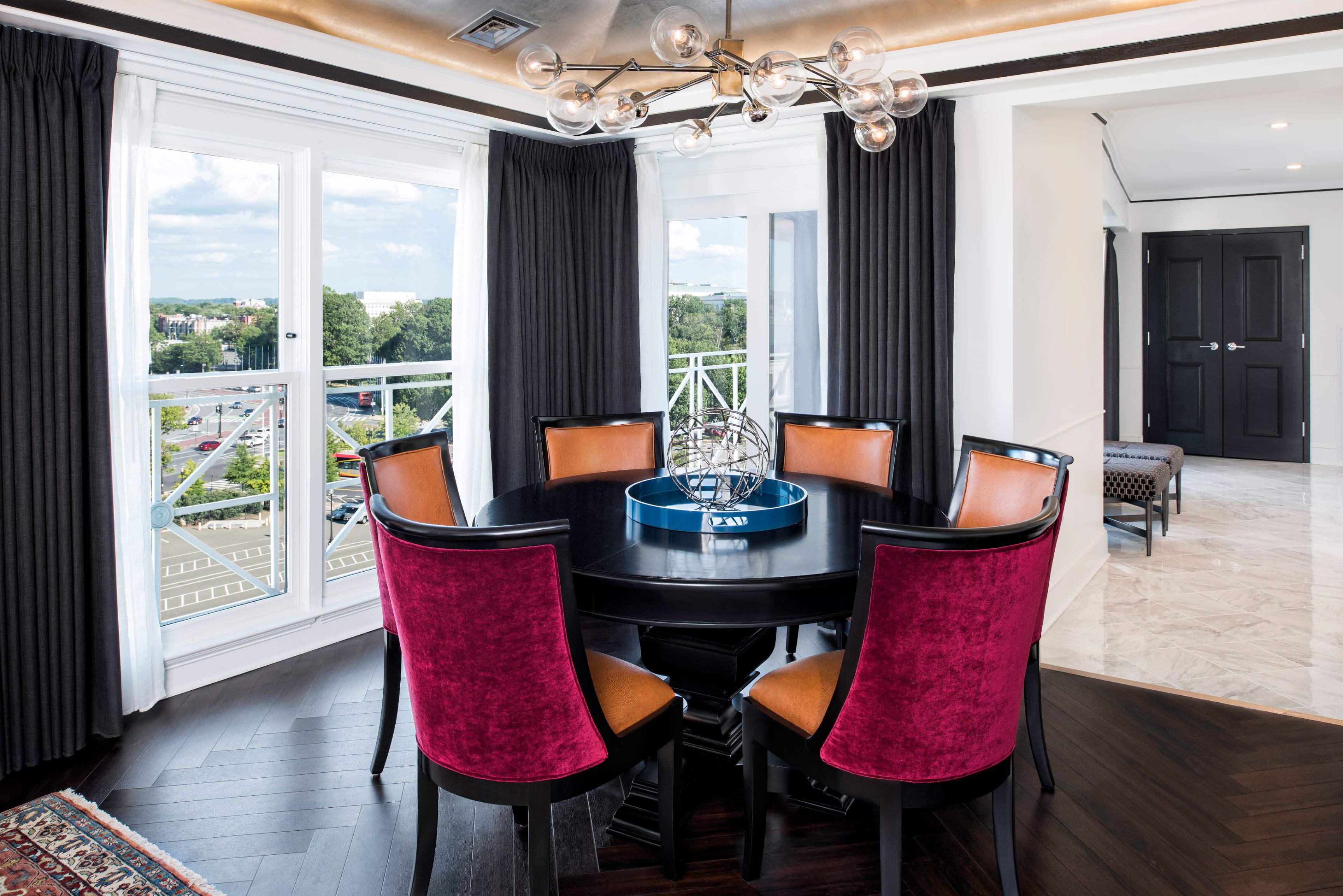 a room with a round table and chairs
