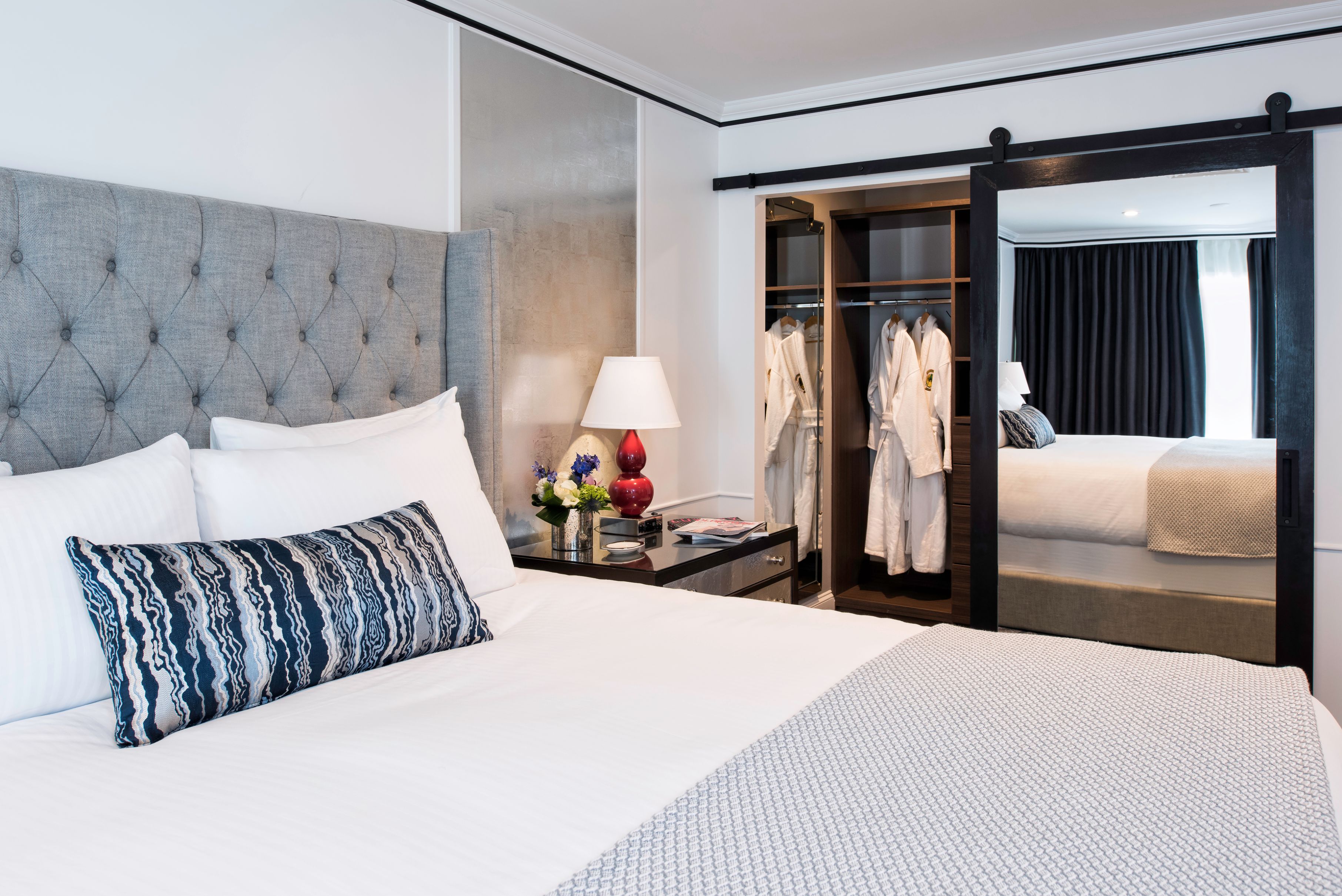 a bedroom with a mirror and a bed