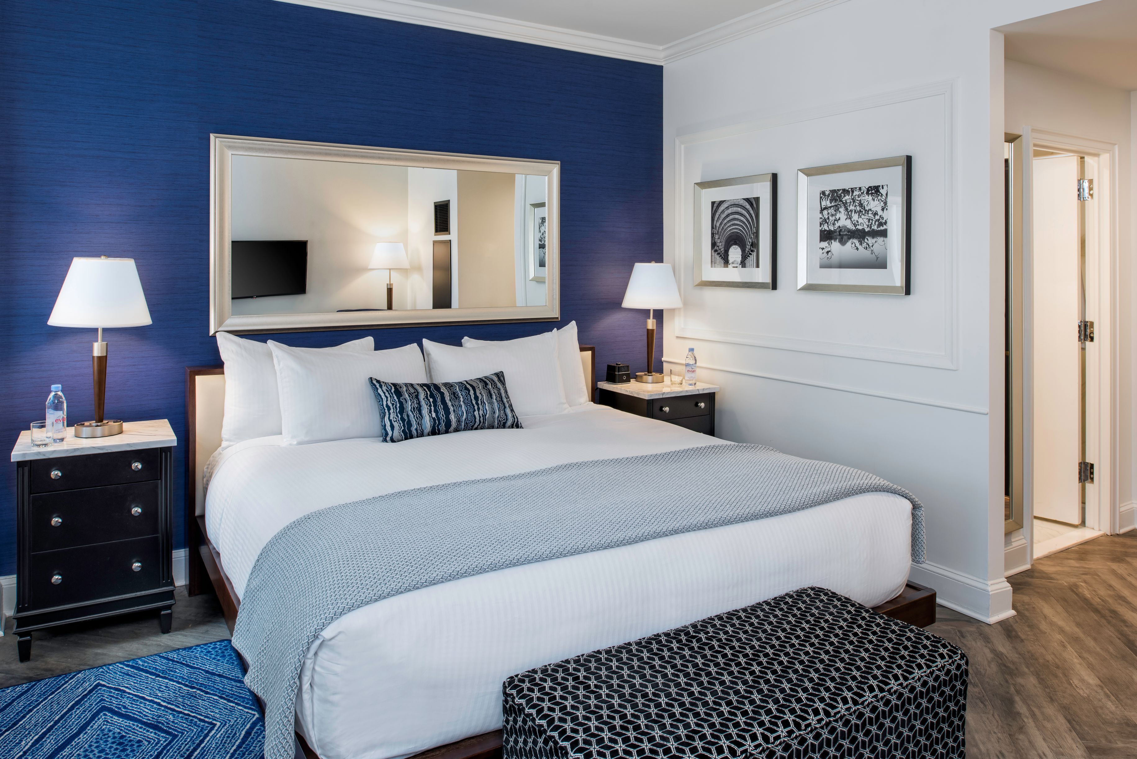 a bed with a mirror above it