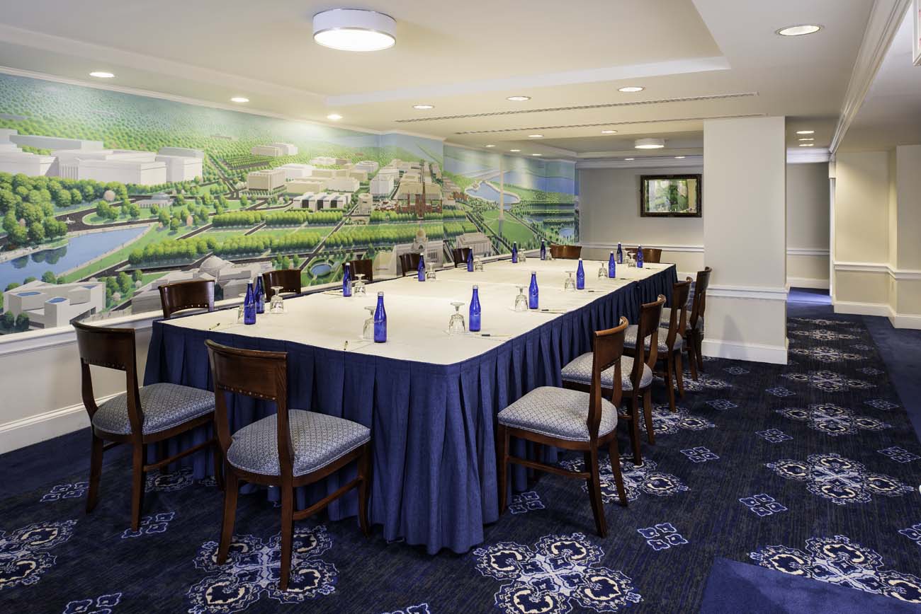 a long table with blue bottles and blue tablecloth