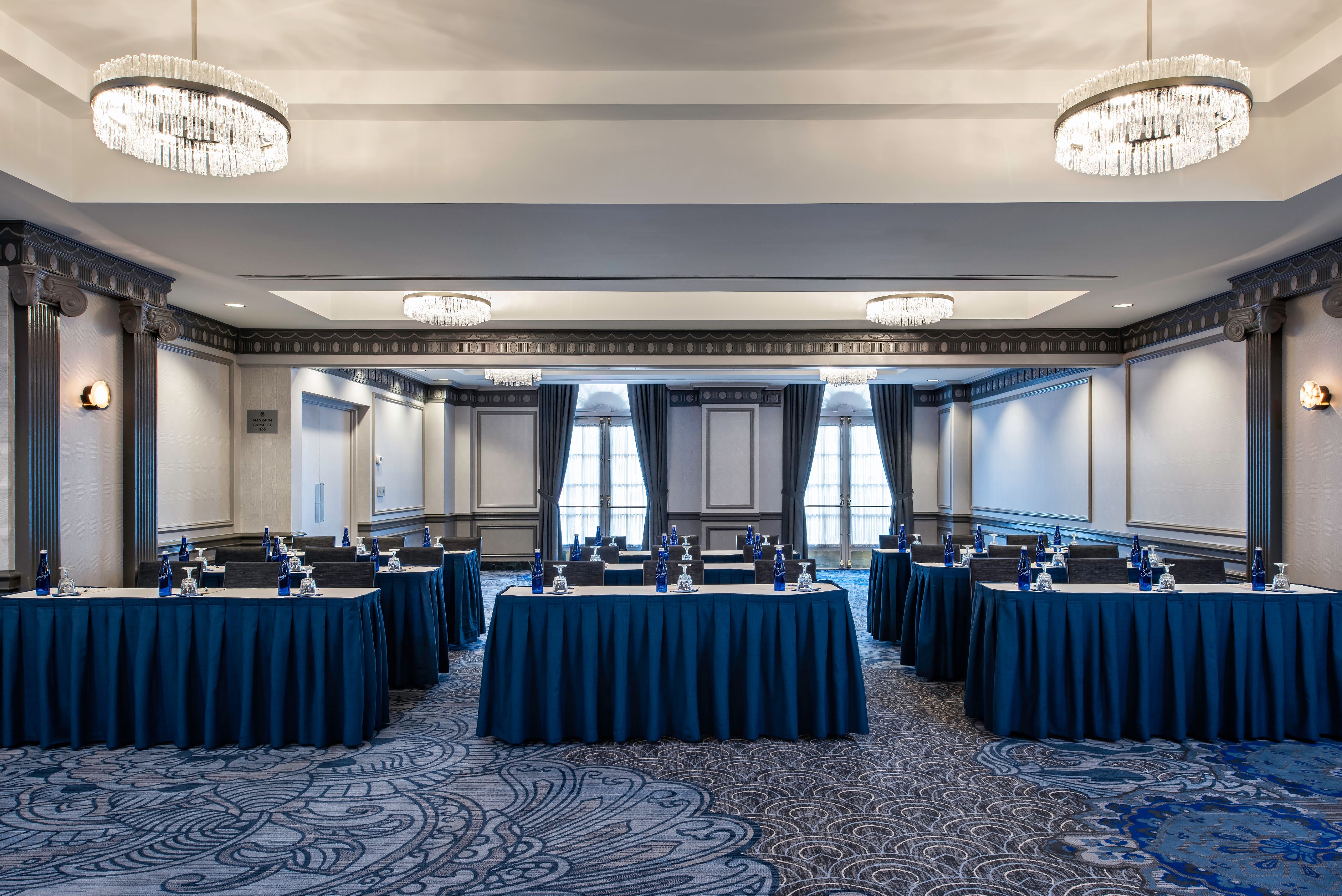 a room with tables and blue cloths