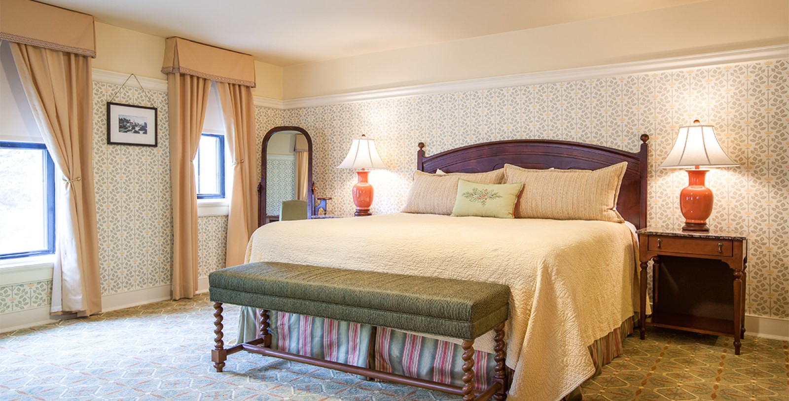 a bed with a bench in a bedroom