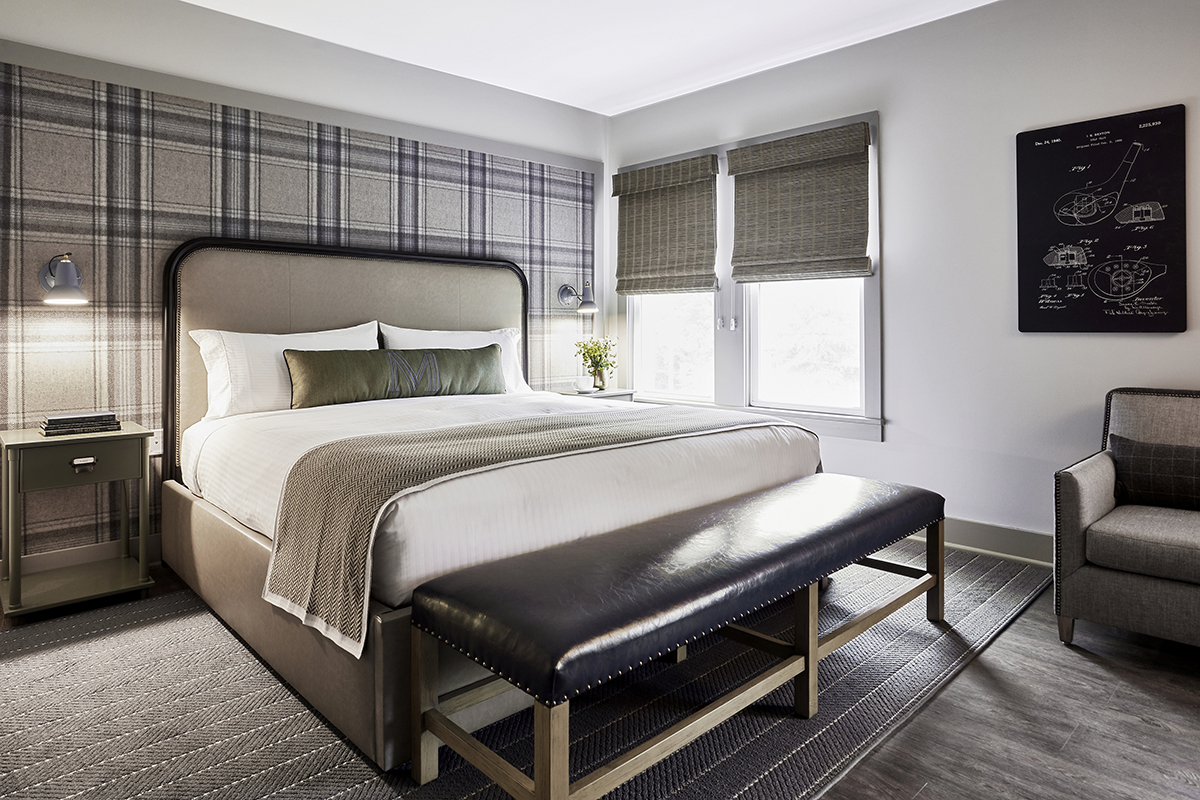 a bed with a bench in a room