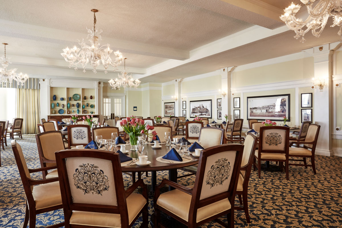 a room with a round table and chairs