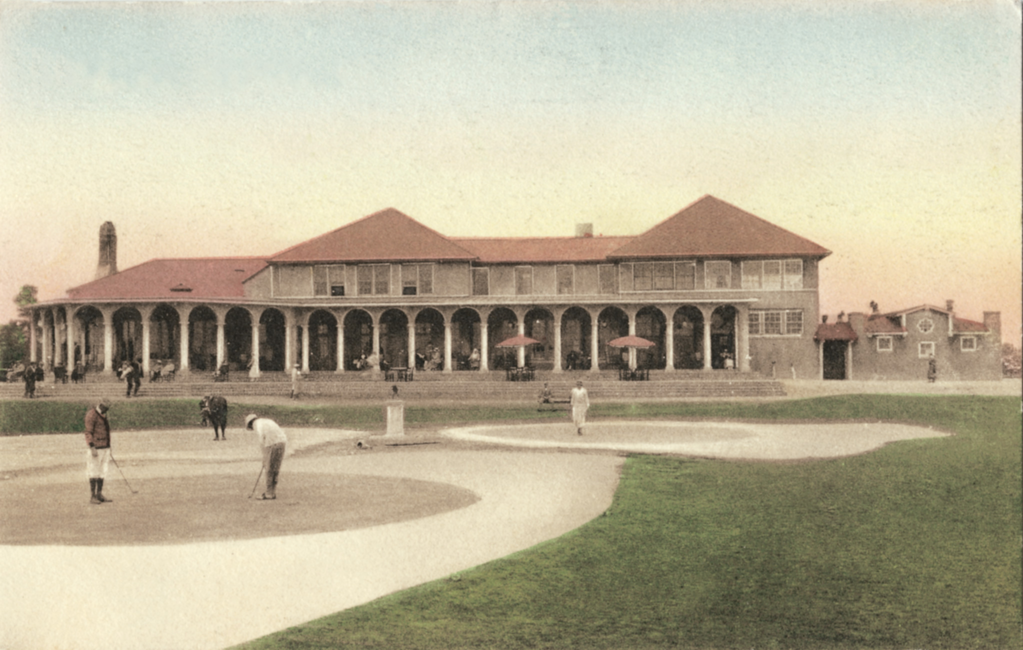 a building with a large porch and a large building with columns