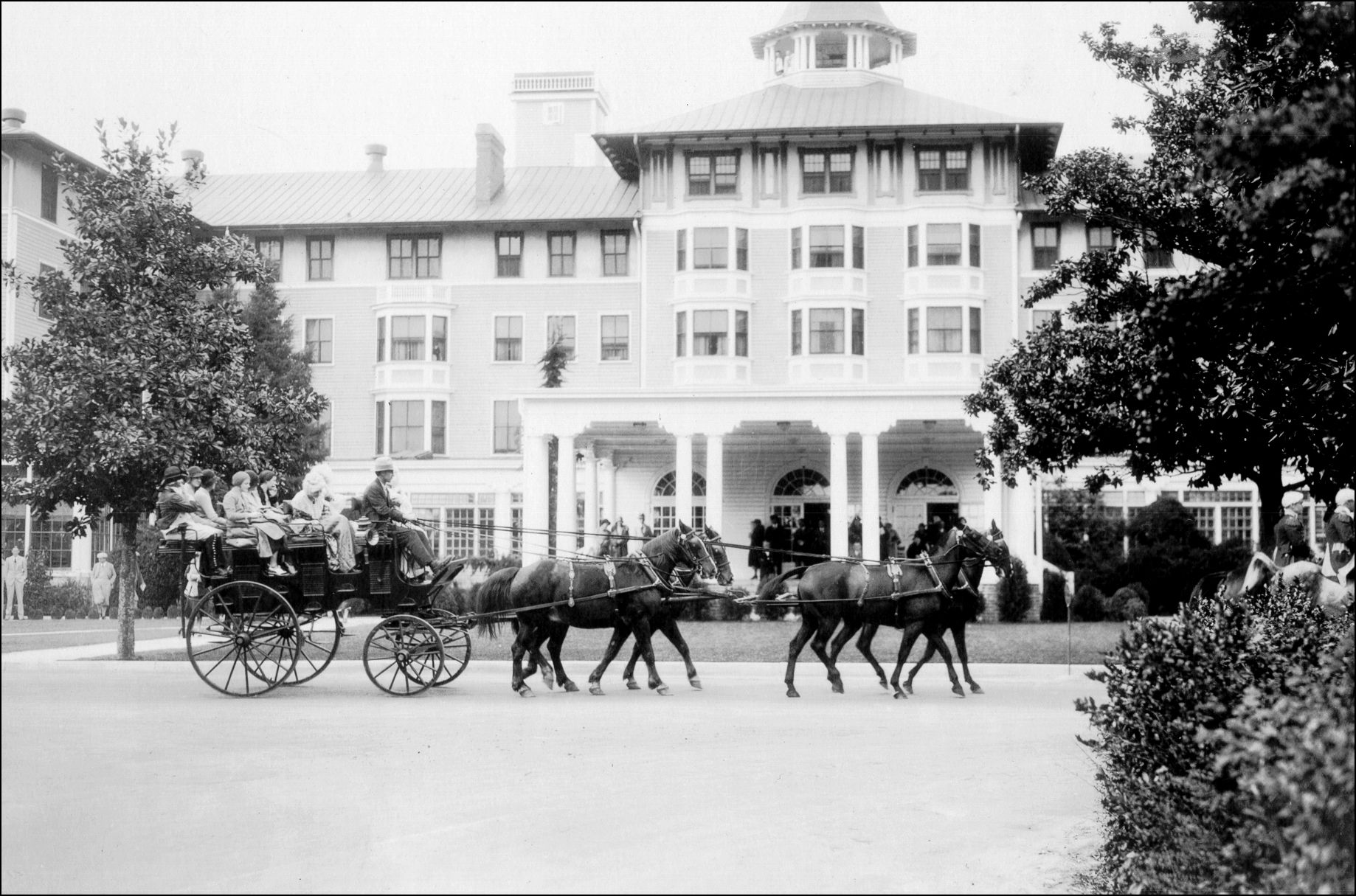 a horse drawn carriage with horses pulling people