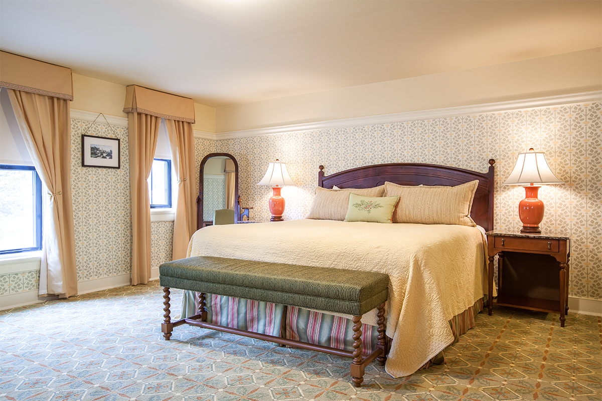 a bed with a bench in a room