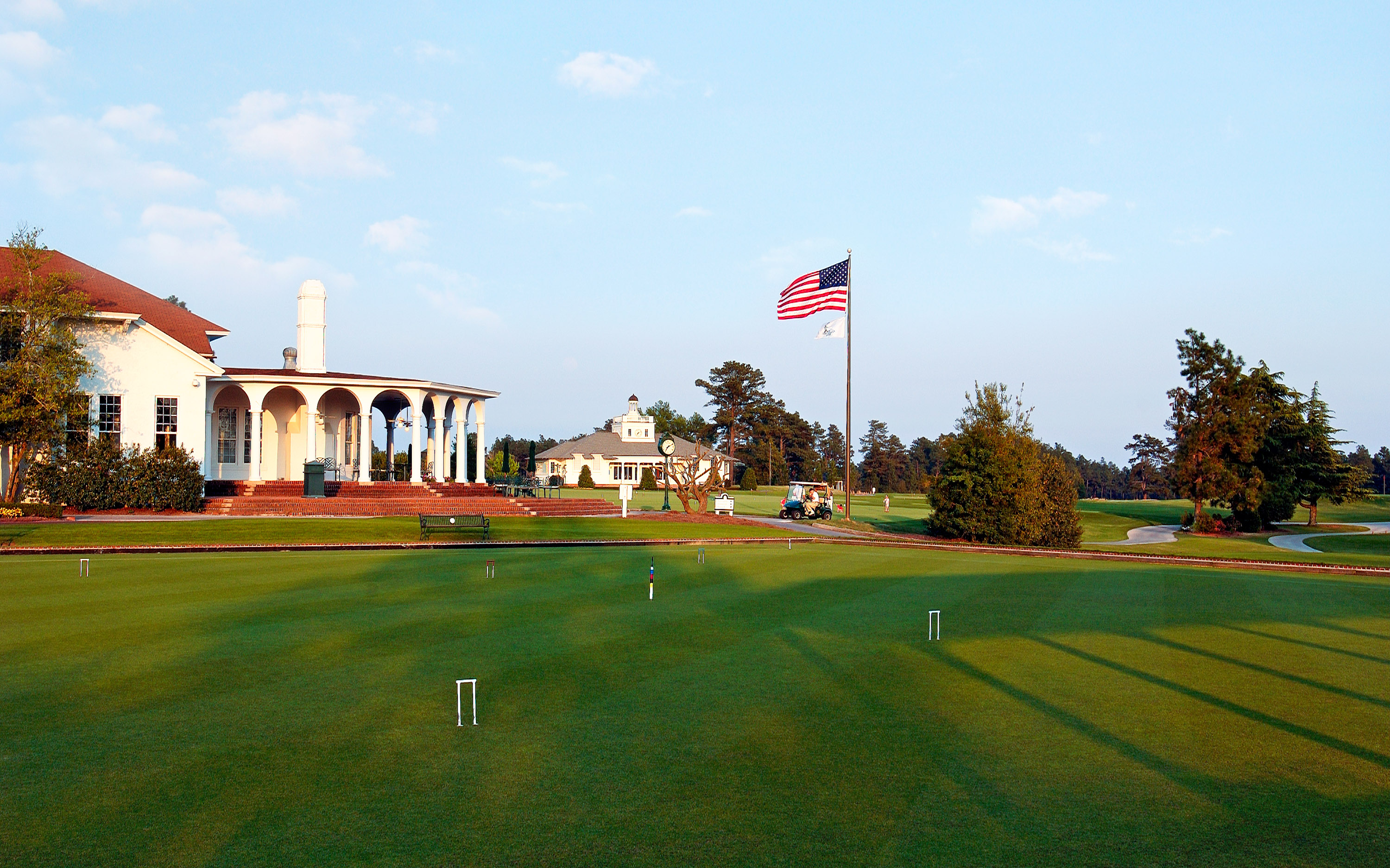 a golf course with a flag on the pole