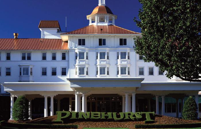 a large white building with a copper roof