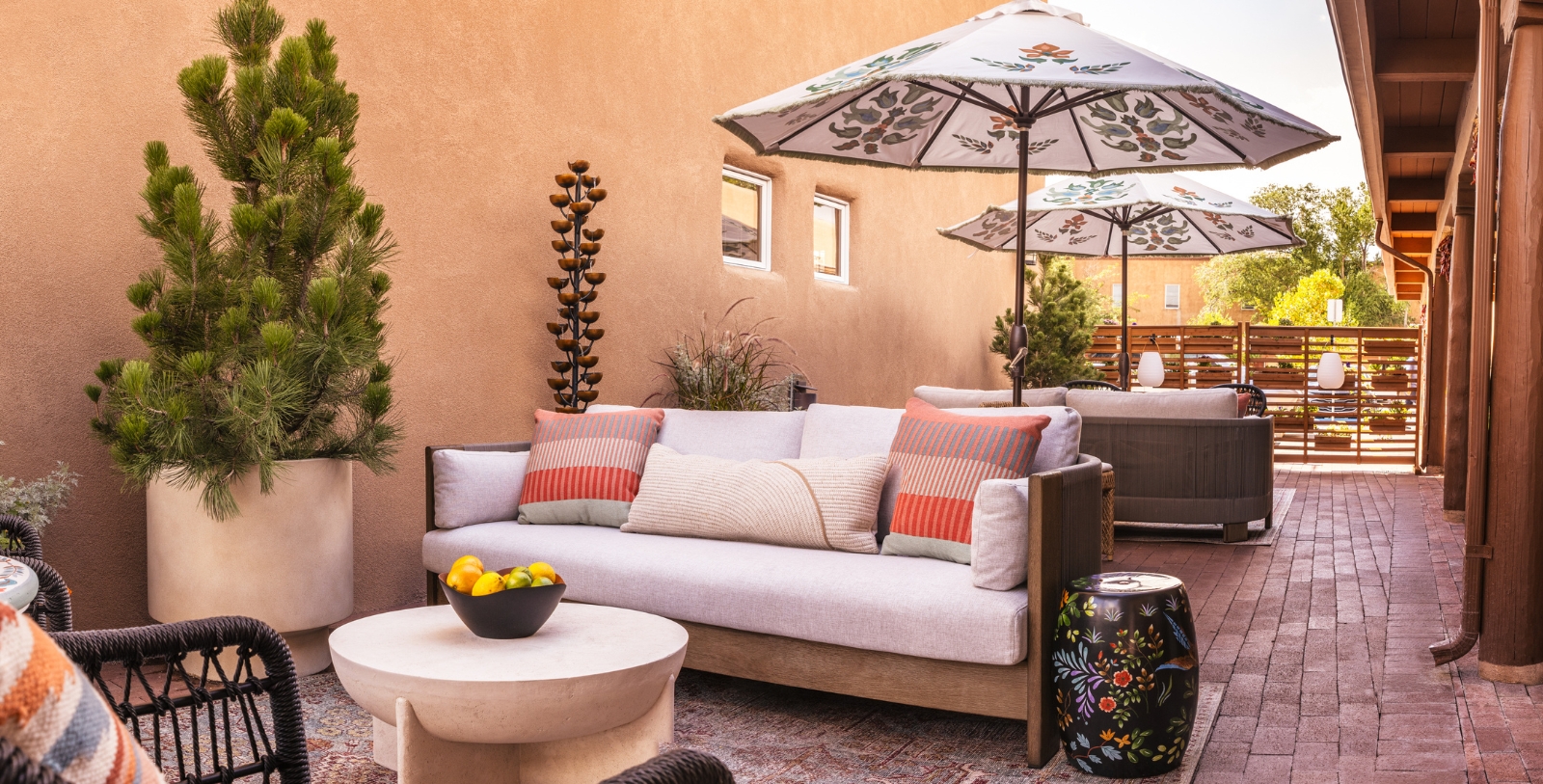a patio with a couch and umbrella
