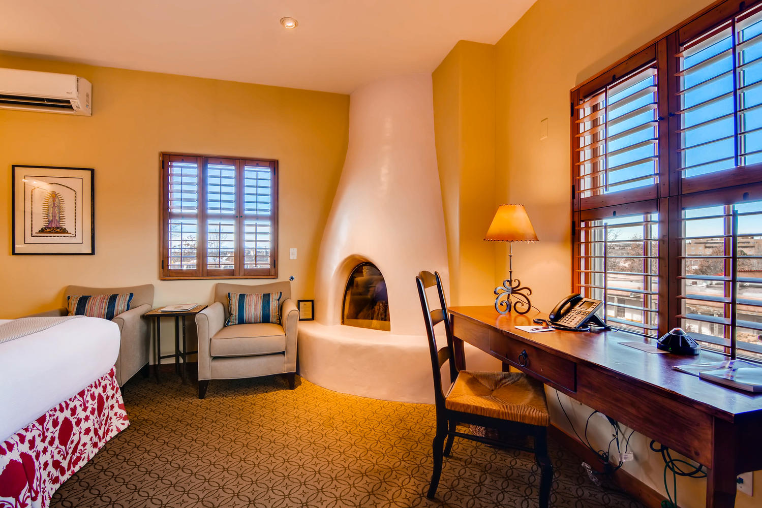 a room with a fireplace and a desk