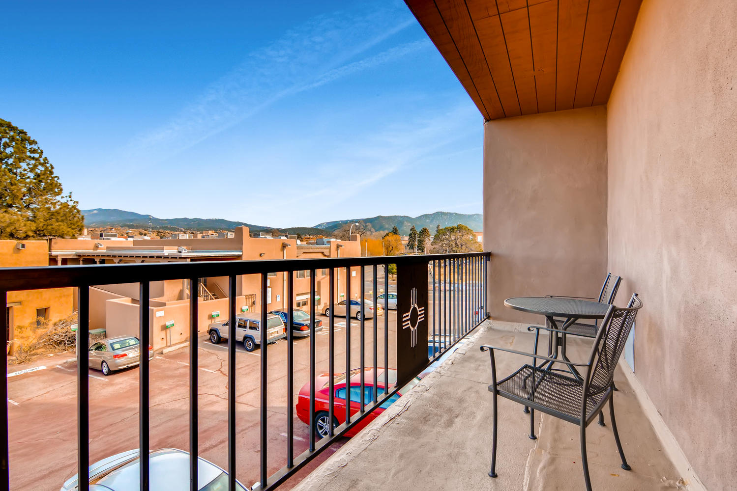 a balcony with a table and chairs