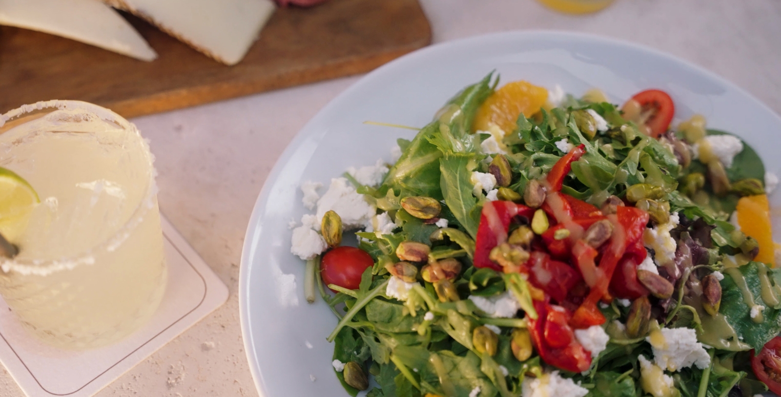 a plate of salad with tomatoes and cheese
