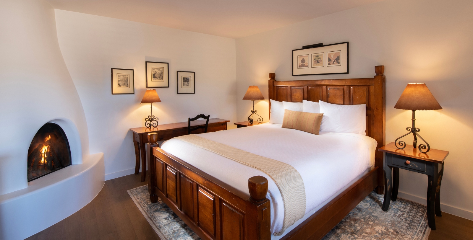 a bed with a wood headboard and lamp