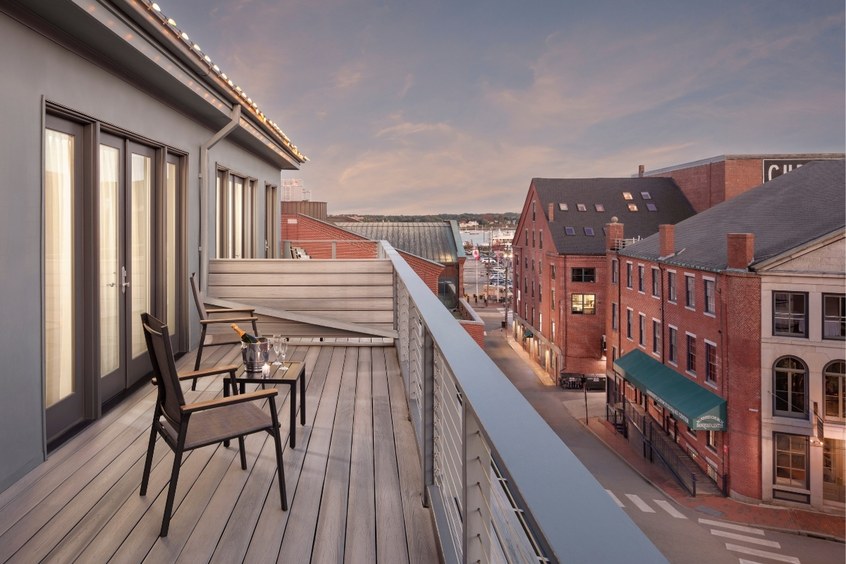a balcony with chairs and a table on it