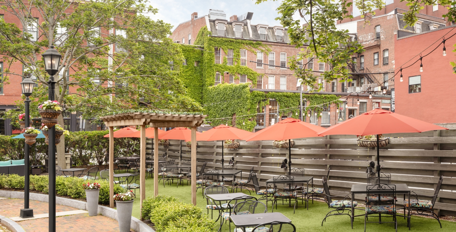 a patio area with tables and umbrellas