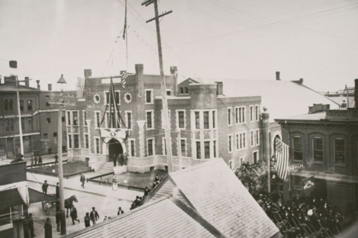 a building with flags and people in the background