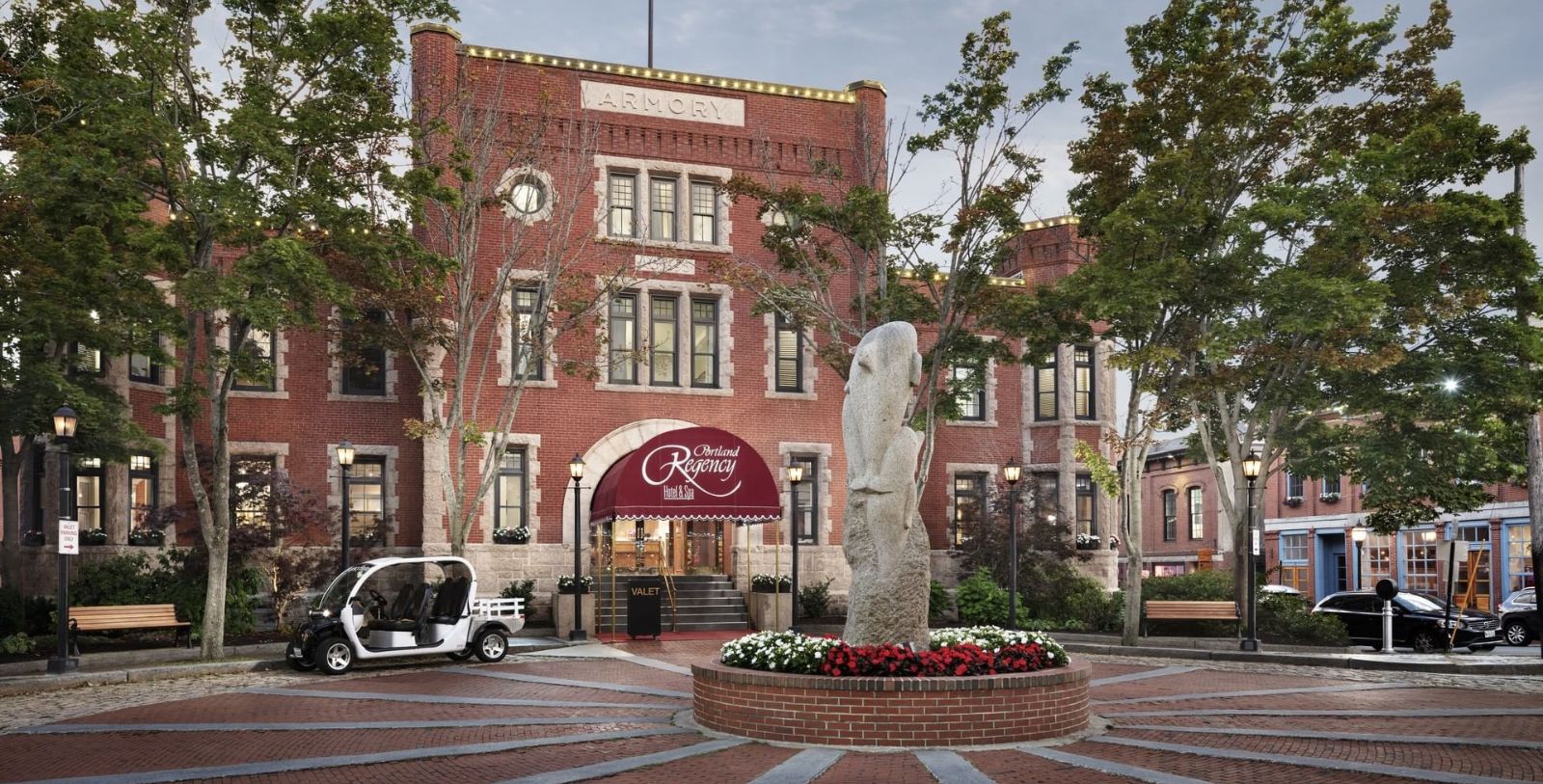 a stone statue in front of a building