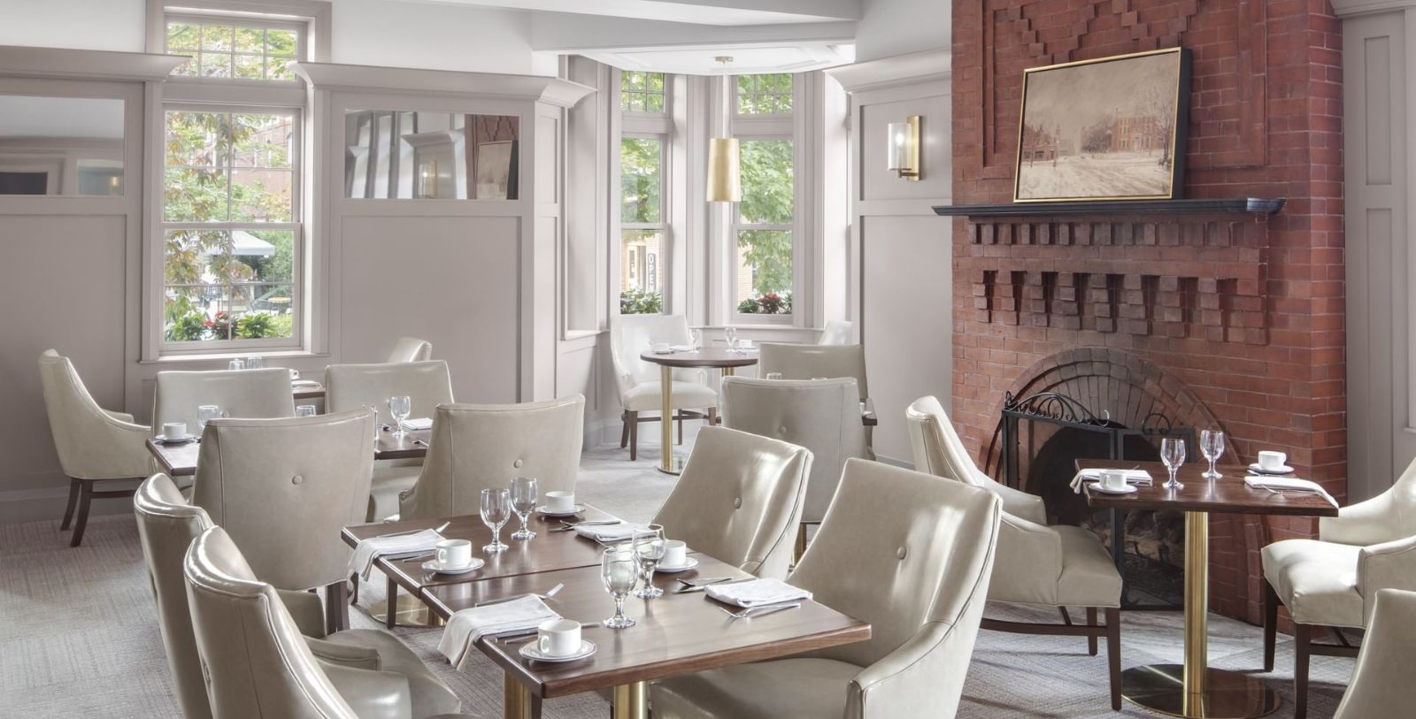 a room with a fireplace and tables and chairs