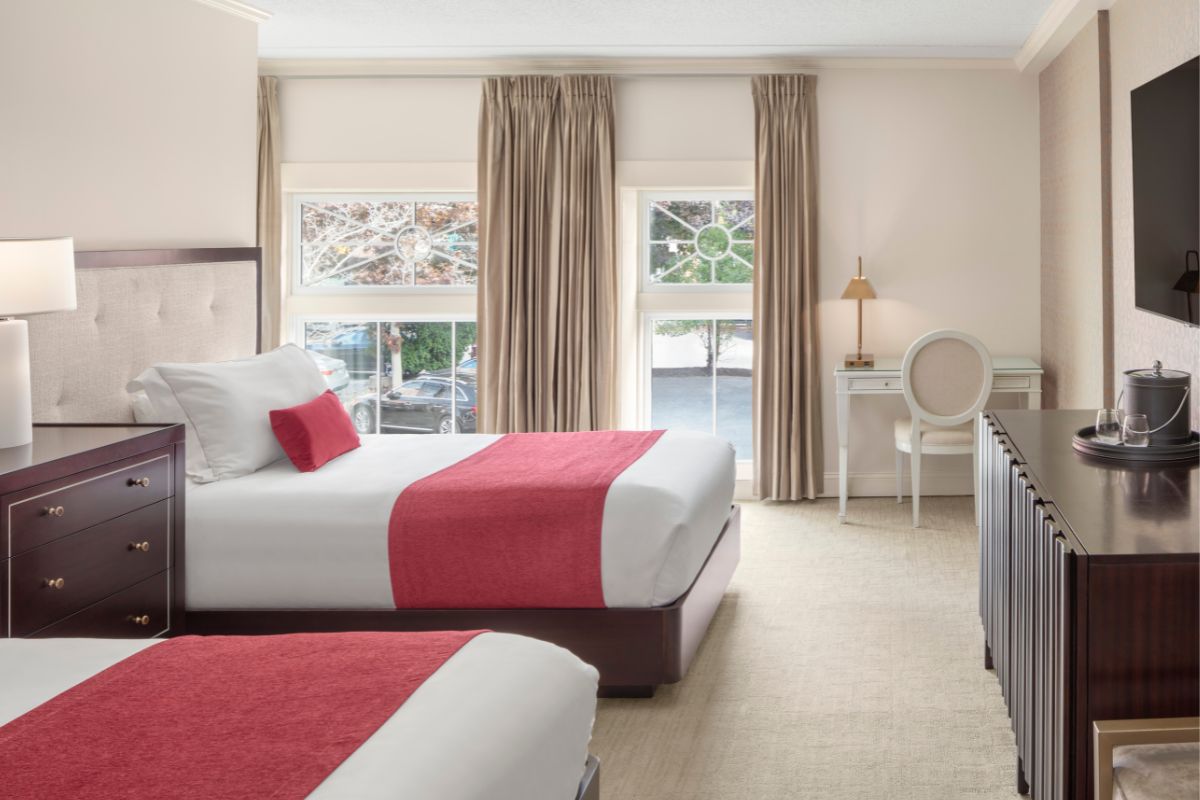 a room with two beds and a desk