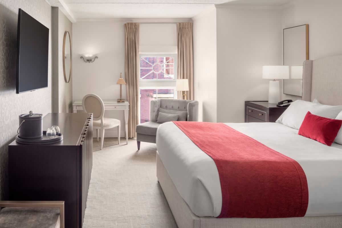 a bedroom with a bed and a desk