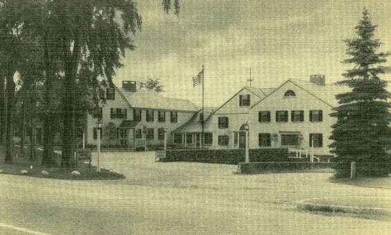 a large white building with a flag on the front