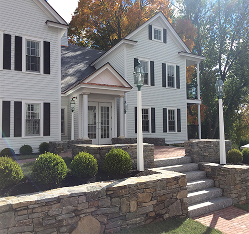 a house with stone walls and a stone wall