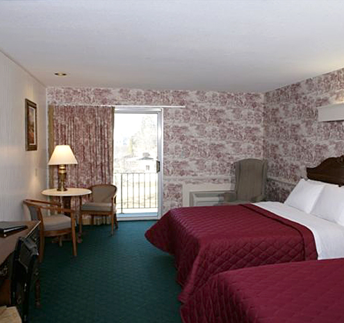 a room with two beds and a table
