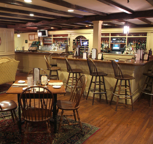 a bar with chairs and tables