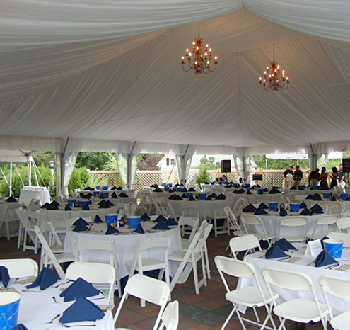 a large tent with tables and chairs