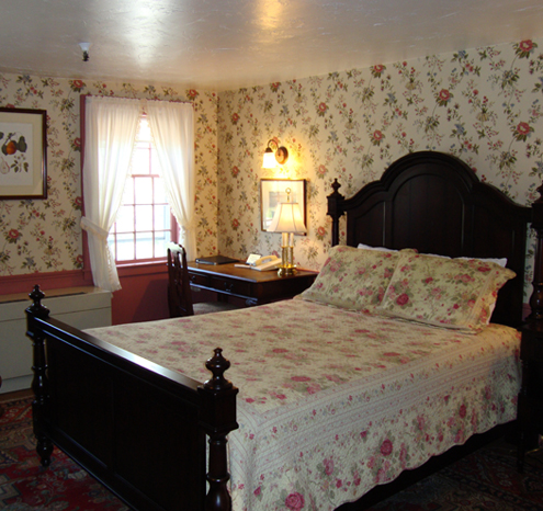 a bedroom with a bed and a desk