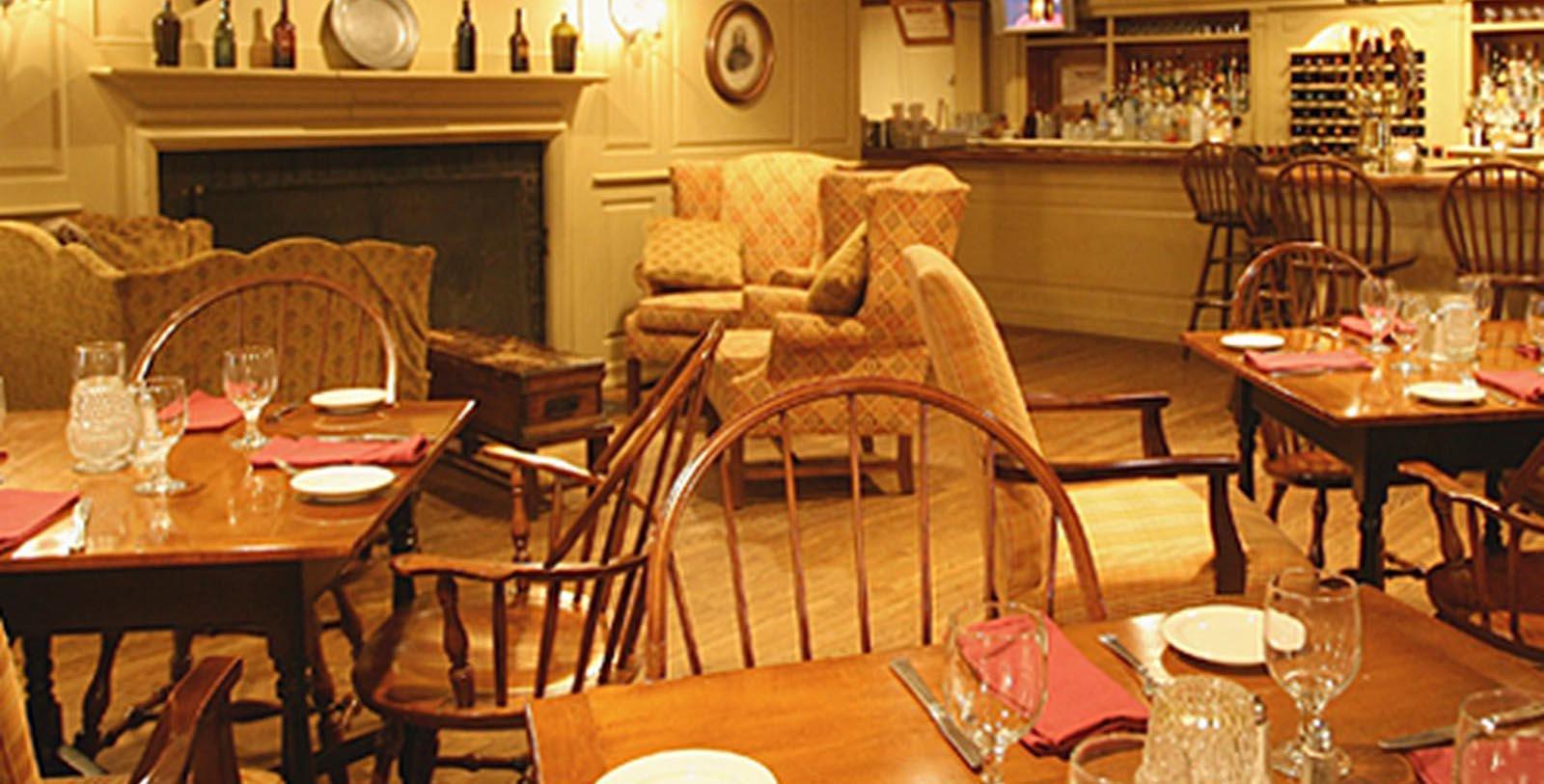 a dining room with a fireplace and chairs