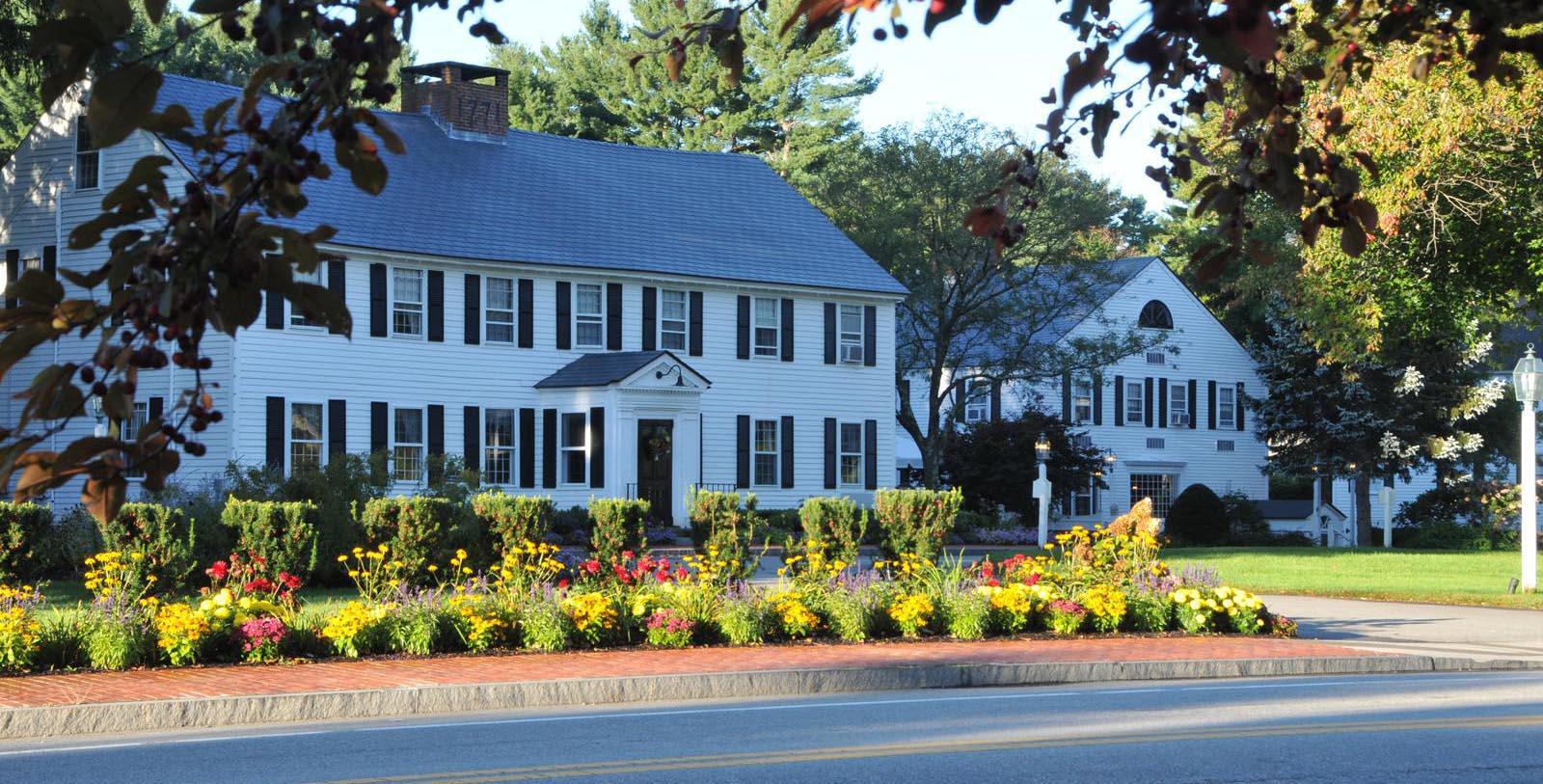a white house with a flower garden