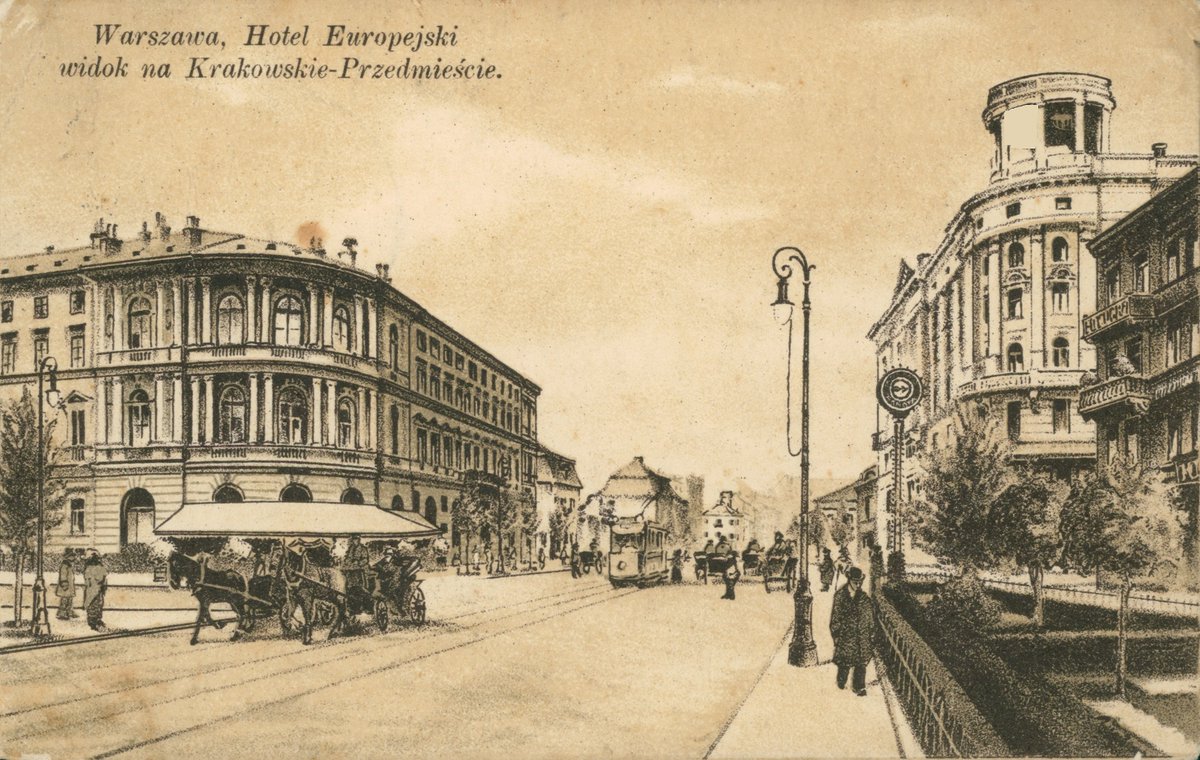 a black and white photo of a street with a building and a carriage