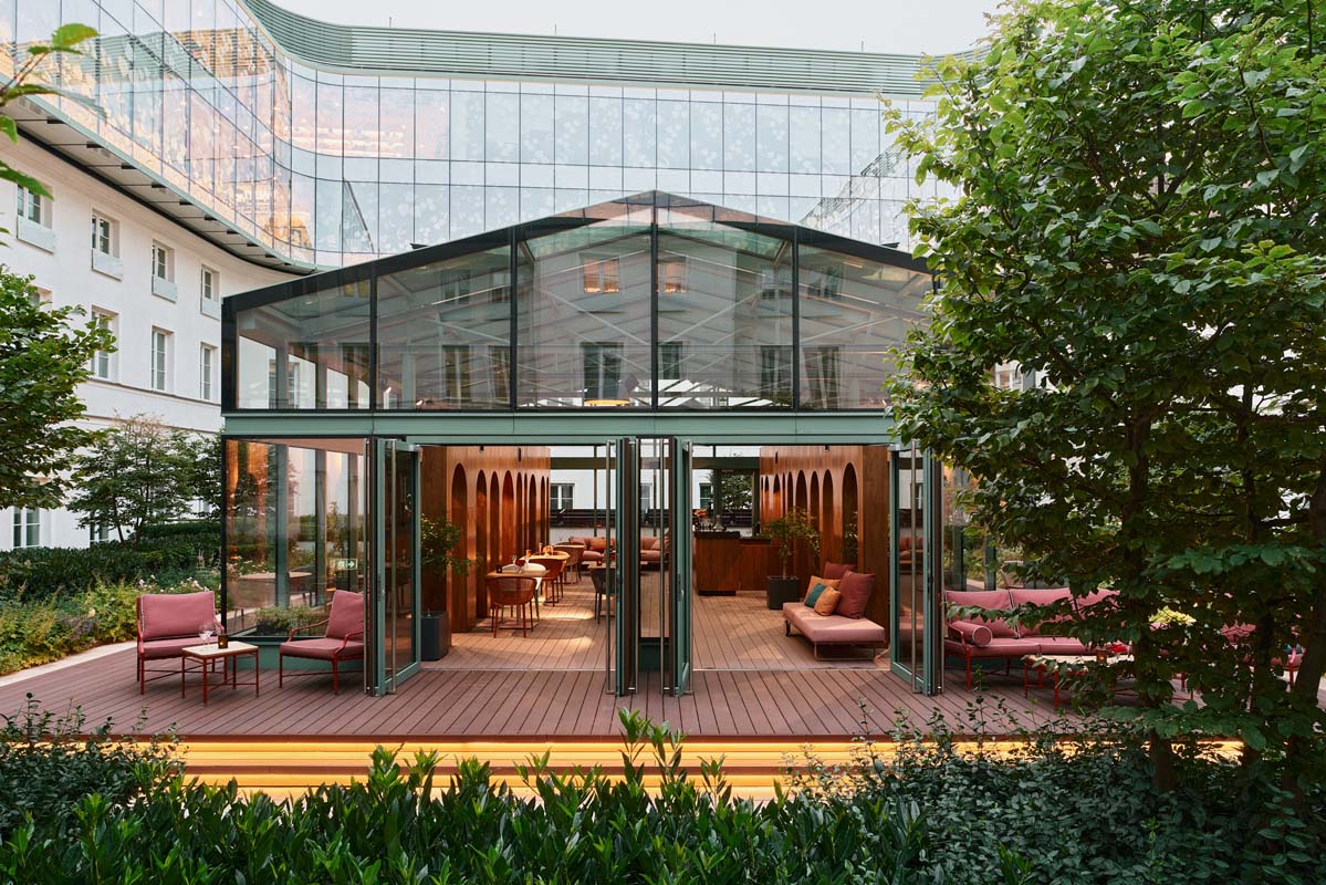 a glass building with a glass wall and a glass roof