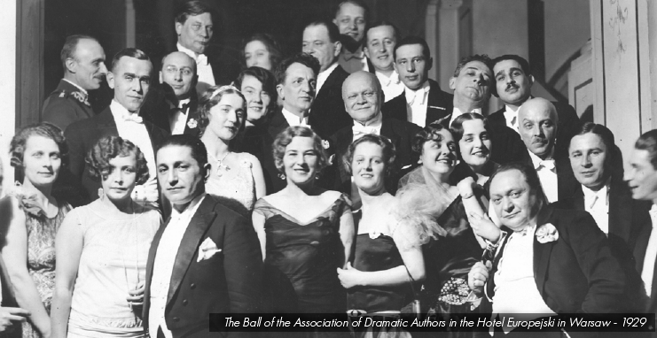 A historical black-and-white group photograph of a large crowd of smartly dressed men in tuxedos and women in 1920s formal dresses, with an overlaid caption at the bottom reading 'The Ball of the Association of Dramatic Authors in the Hotel Europejski