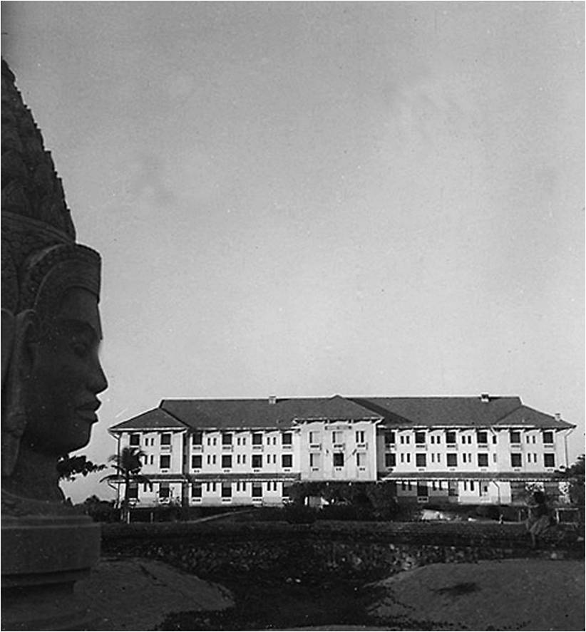 a large building with a statue in the background