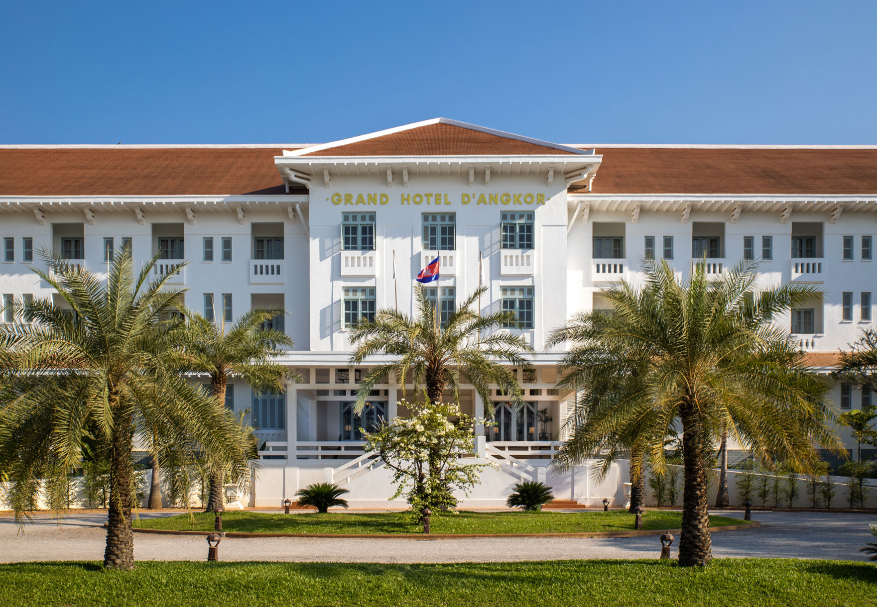 a white building with palm trees