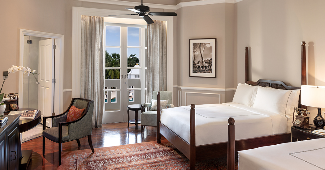 a bedroom with a bed and chairs
