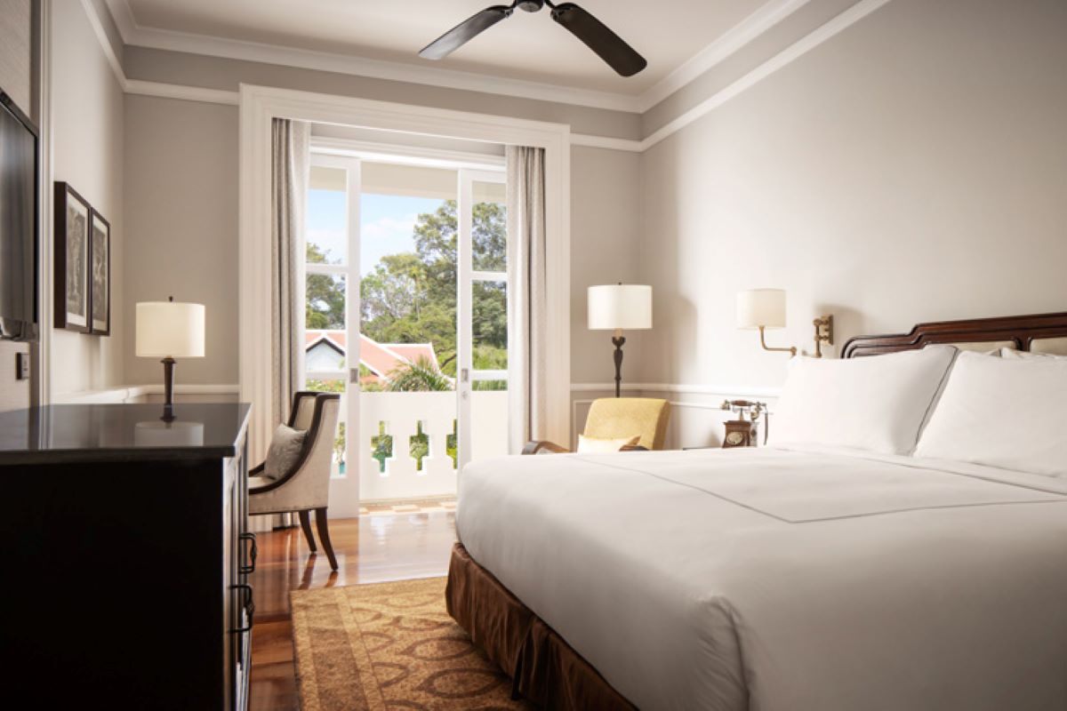 a room with a bed and a fan