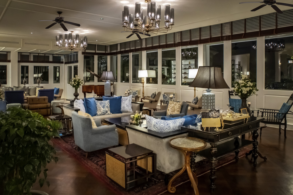 a room with a large chandelier and couches