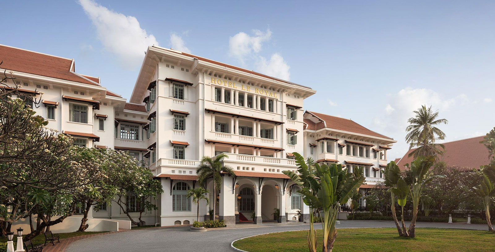 a building with a lawn and palm trees