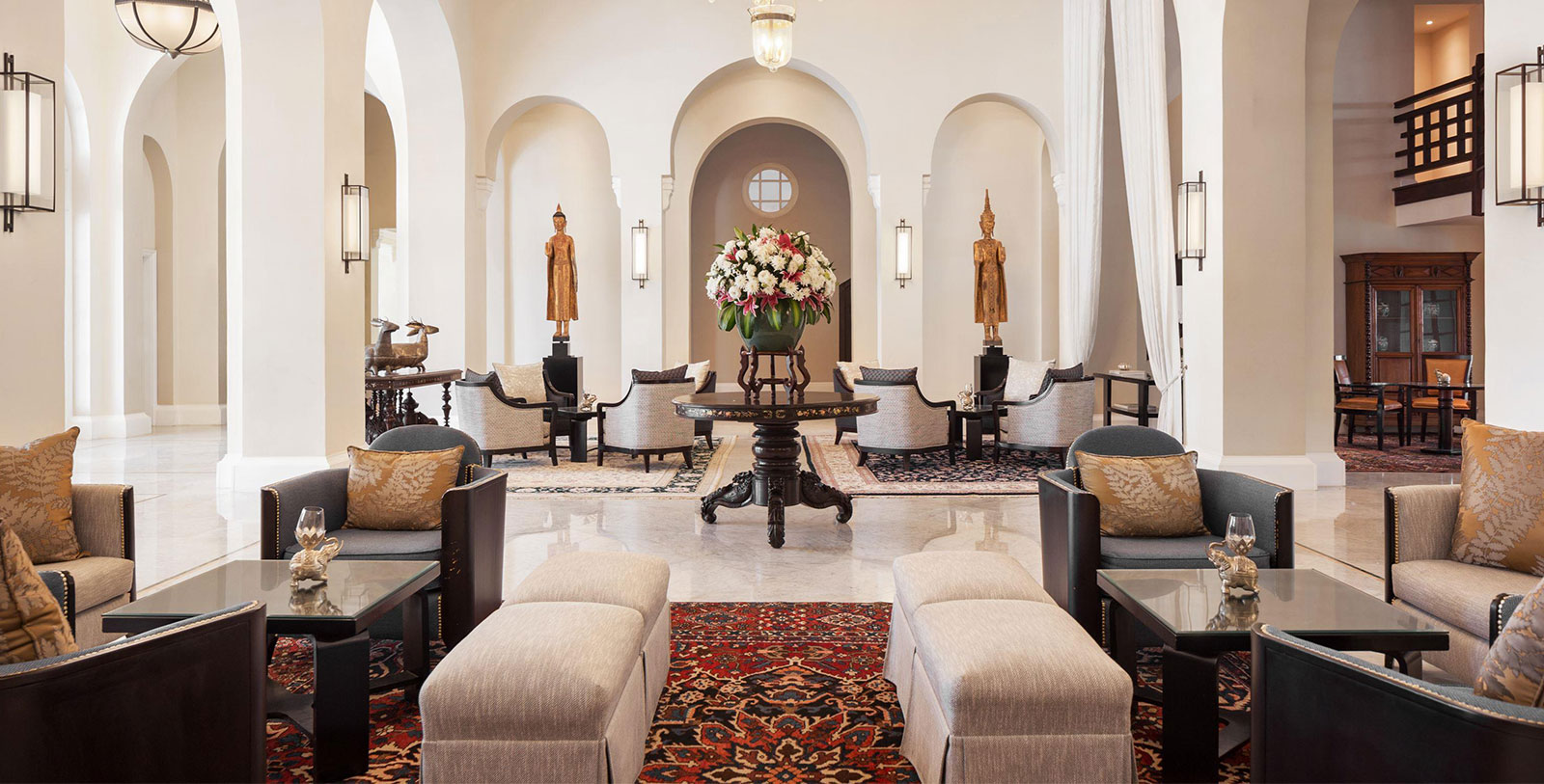 a room with a table and chairs and a vase of flowers