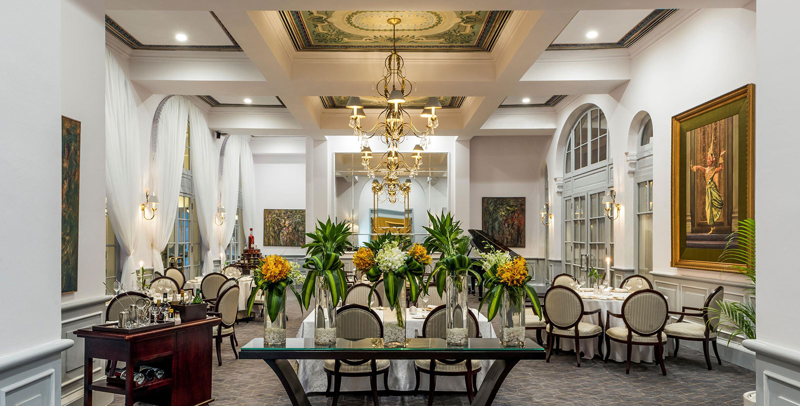 a room with a chandelier and flowers