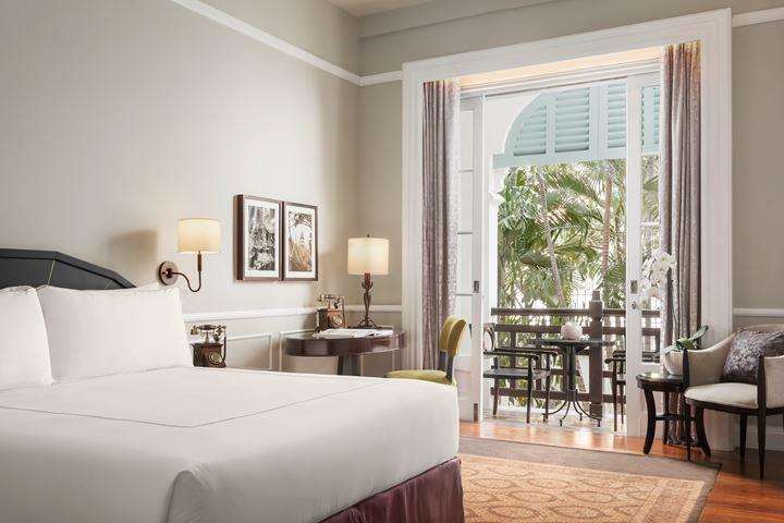 a room with a bed and a table and chairs