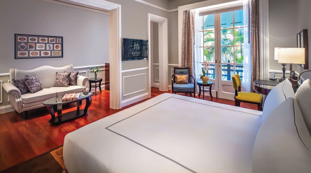 a room with a bed and chairs